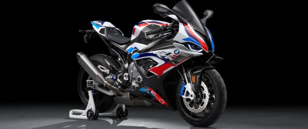 A BMW M 1000 RR is showcased with its detailed design and colors against a dark studio background, 2K Desktop Wallpaper