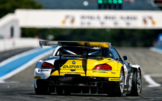 A BMW racing car is speeding down the race track under clear skies, HD Desktop Wallpaper
