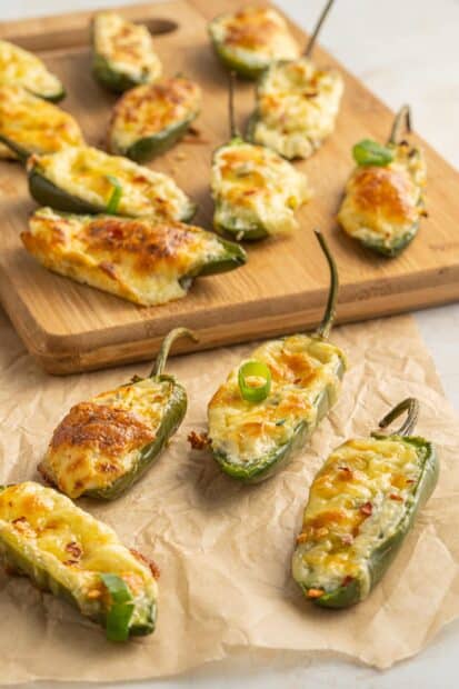 Baked jalapeno stuffed with melted cheese on a wooden board, 2K Mobile Wallpaper