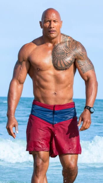 A muscular man with a tribal tattoo walks out of the ocean in Baywatch movie, 4K Mobile Wallpaper