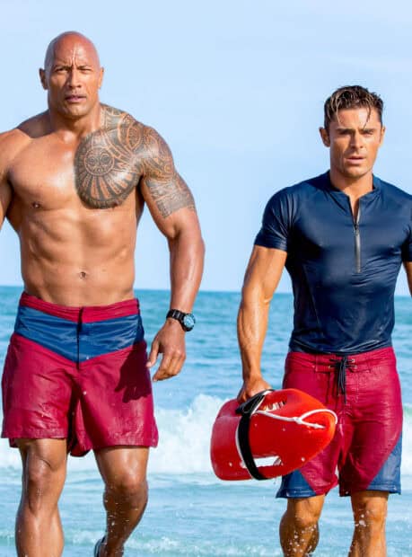 The Baywatch movie lifeguard duo walks out of the ocean with rescue equipment, HD Mobile Wallpaper