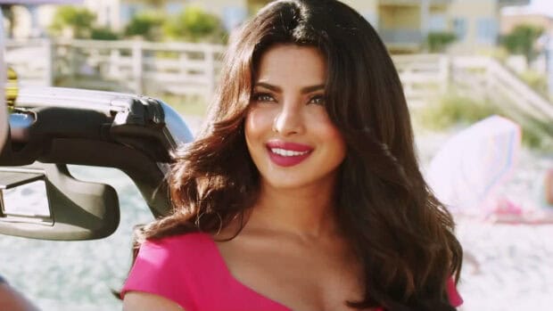 A close up of a smiling woman from Baywatch Movie wearing a pink dress near a beach setting, HD Desktop Wallpaper