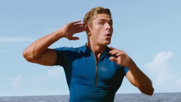 A man in a blue shirt reacts surprised by the ocean in Baywatch movie wallpapers, HD Desktop Wallpaper