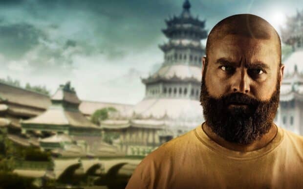 A serious Zach Galifianakis stands with a historical building in the background, HD Desktop Wallpaper