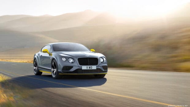 A Bentley Continental GT driving along a scenic highway with hills in the background, 4K Desktop Wallpaper