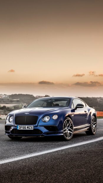 A blue Bentley Continental GT parked on a racetrack during sunset, 2K Mobile Wallpaper