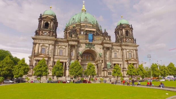 The Berlin Cathedral stands prominently with its green dome and detailed architecture under a cloudy sky, 4K Desktop Wallpaper