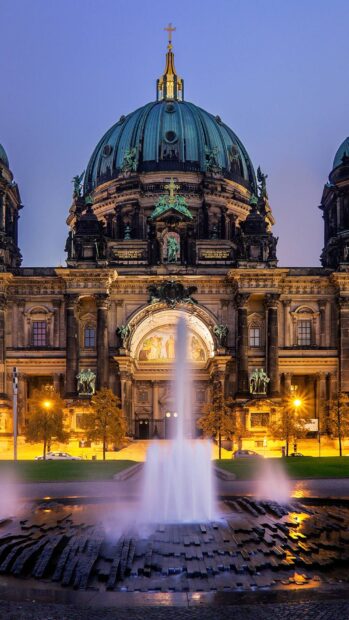 The Berlin Cathedral is beautifully illuminated with a fountain in the foreground at dusk, HD Phone Wallpaper
