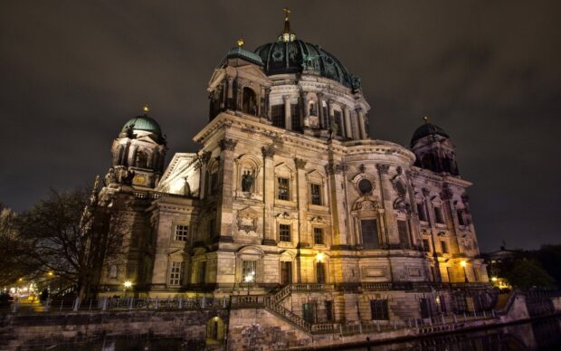 The Berlin Cathedral is beautifully illuminated against the night sky, showcasing its detailed architecture, HD Desktop Wallpaper