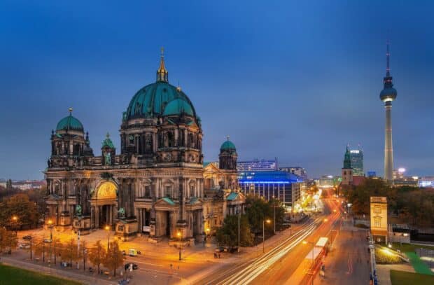 The Berlin Cathedral stands prominently with city lights and traffic trails in the evening, HD Desktop Wallpaper