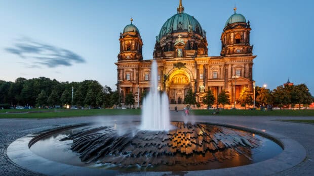 The Berlin Cathedral stands illuminated with a fountain flowing peacefully in the foreground, 4K Desktop Wallpaper