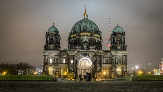The Berlin Cathedral is beautifully lit at night with its dome glowing and nearby buildings visible, HD Desktop Wallpaper