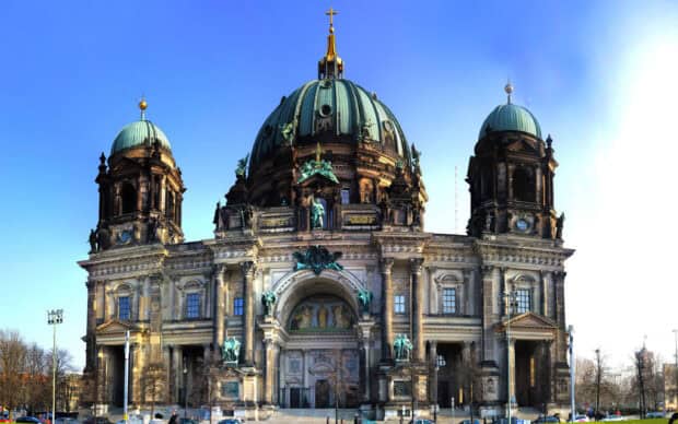 The Berlin Cathedral stands prominently with its green domes and detailed sculptures under a clear blue sky, 2K Desktop Wallpaper