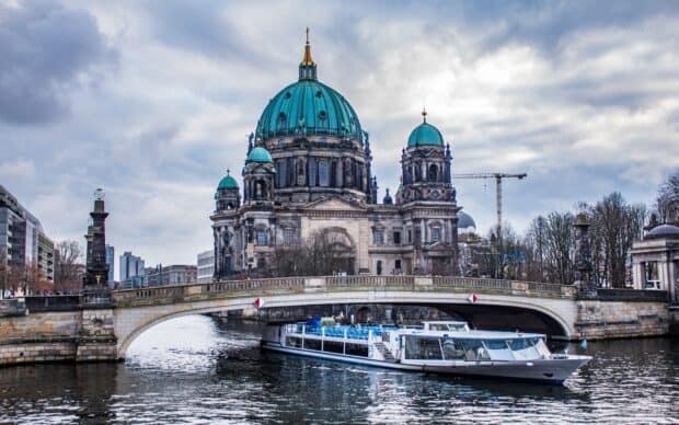 A large boat sails on the river near Berlin Cathedral under a cloudy sky, HD Desktop Wallpaper