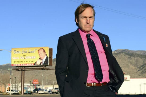 Saul Goodman stands confidently near a billboard promoting his law services, HD Desktop Wallpaper