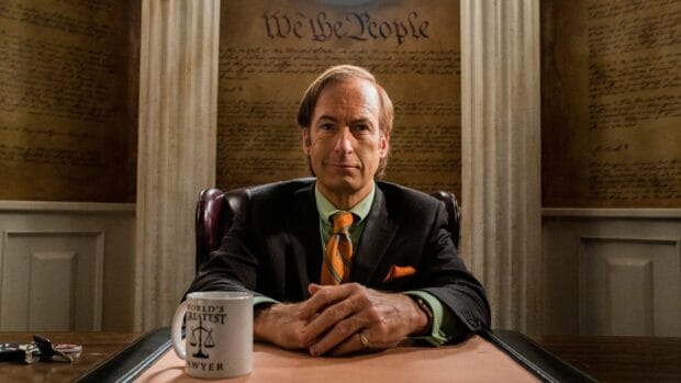 A man sits confidently behind a desk in a courtroom setting, HD Desktop Wallpaper