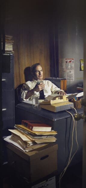 A man in a tie holding a glass sits in a cluttered office reflecting quietly on his case, HD Phone Wallpaper