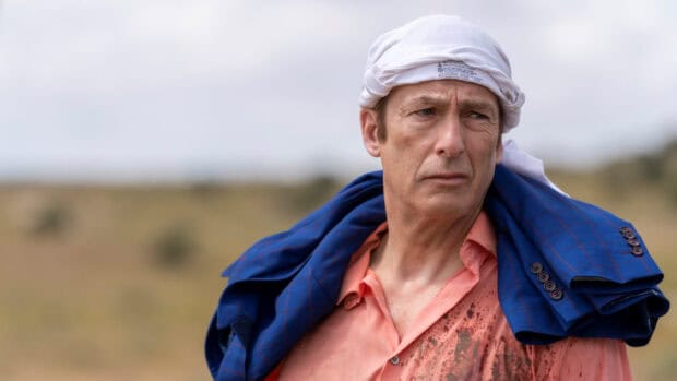 A close up of a man wearing a headscarf and carrying a jacket over his shoulder in a rural setting, HD Desktop Wallpaper