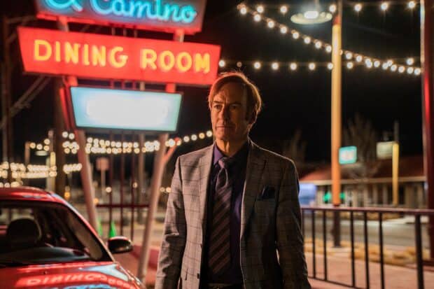 A man in a suit stands near neon dining room signs in this Better Call Saul wallpaper, 2K Desktop Wallpaper