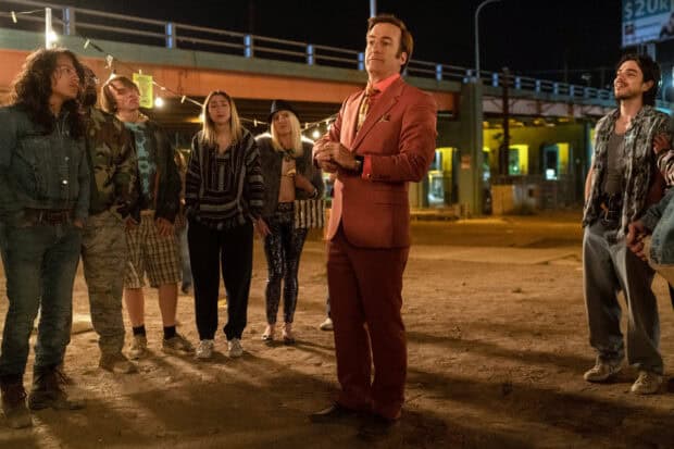 Saul stands confidently among a diverse crowd in a night scene, HD Desktop Wallpaper