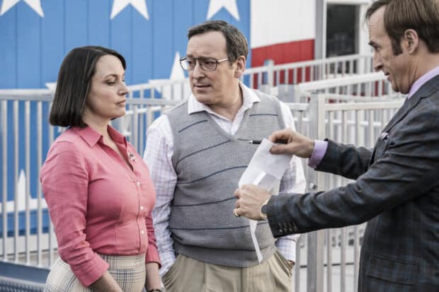 Three Better Call Saul characters discuss a contract in front of a patriotic mural, HD Desktop Wallpaper