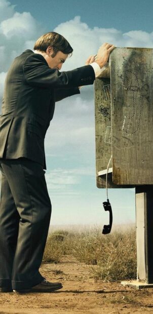A man leans on a weathered phone booth in a desert in Better Call Saul wallpapers, 2K Phone Wallpaper