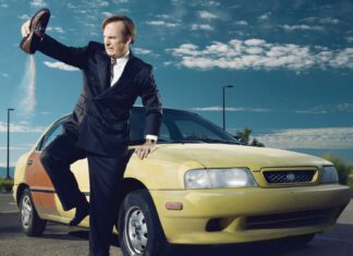 A man in a suit throwing sand from his shoe near a yellow car under a blue sky with clouds, HD Desktop Wallpaper