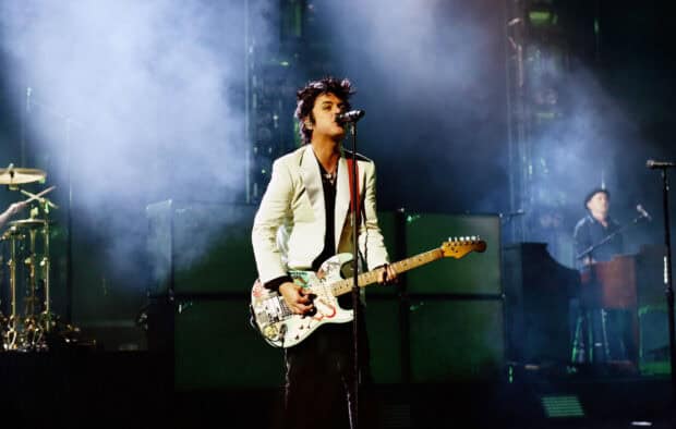 Billie Joe Armstrong is singing and playing guitar during a concert with smoke effects, HD Desktop Wallpaper