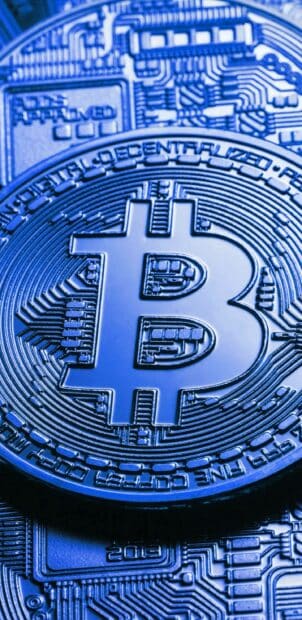 A Bitcoin coin highlights digital decentralized currency concepts, 2K iPhone Wallpaper