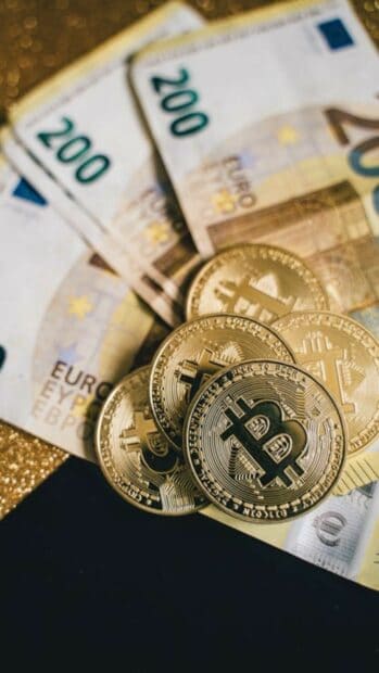 Bitcoin Wallpapers Collection showing golden coins and euros on a dark surface, HD Phone Wallpaper