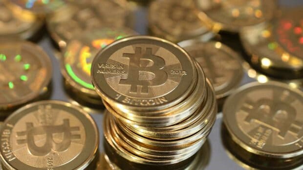 A close up of a stack of golden bitcoins in the Bitcoin Wallpapers Collection, HD Desktop Wallpaper
