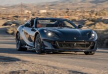 A black Ferrari 812 Gts is driving fast on a desert road with a scenic background, HD Desktop Wallpaper