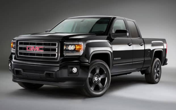A black GMC Sierra truck is shown in a studio setting with detailed front and side views, HD Desktop Wallpaper