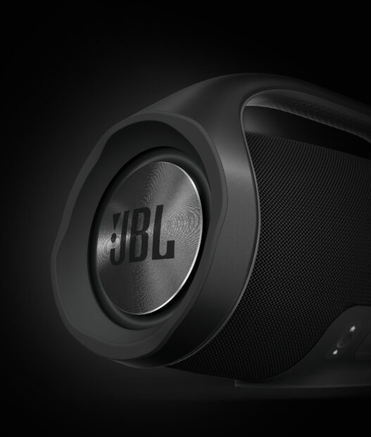 A close up view of a black JBL speaker showing the metallic logo and textured surface, HD Desktop Wallpaper