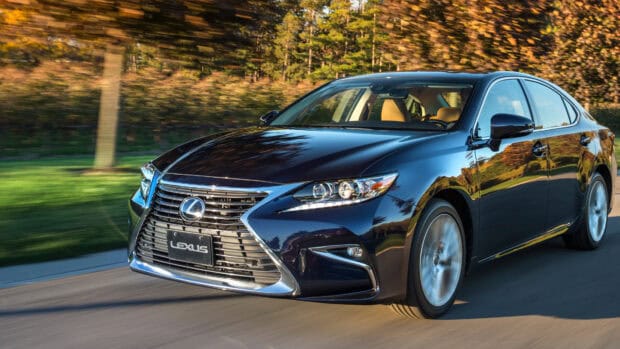 A black Lexus Es is driving swiftly with trees blurred in the background, 4K Desktop Wallpaper