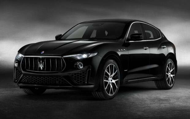 The black Maserati Levante is shown parked with detailed front headlights and grille, HD Desktop Wallpaper