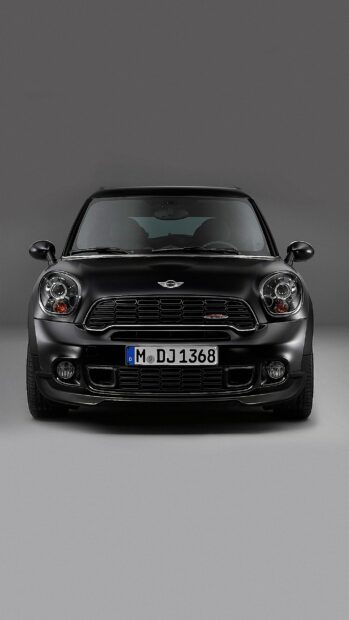 A black Mini Cooper is shown from the front against a gray background in this Mini Cooper Wallpapers, 2K Phone Wallpaper