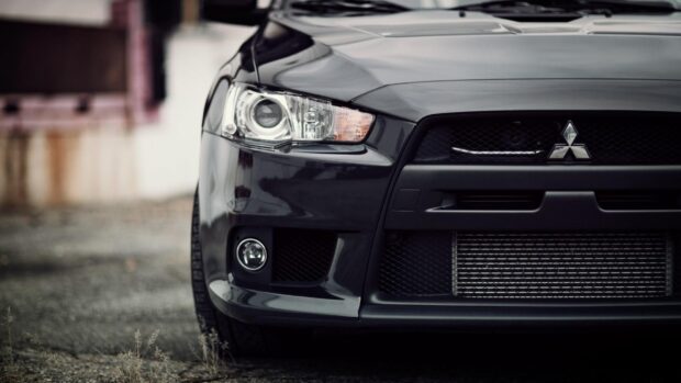 Black Mitsubishi Lancer Evo shows detailed front grille and headlights, HD Desktop Wallpaper
