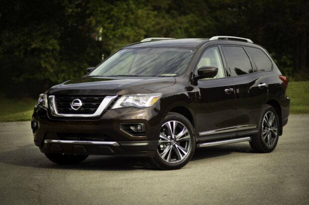 A black Nissan Pathfinder is parked on a road with trees in the background, HD Desktop Wallpaper