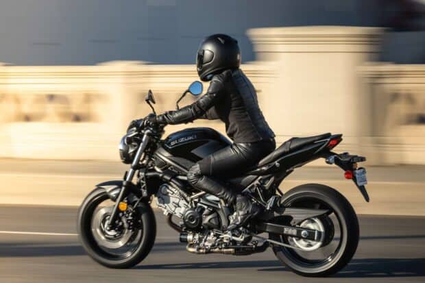 A rider wearing black gear rides a Suzuki Sv650 motorcycle on the road, HD Desktop Wallpaper