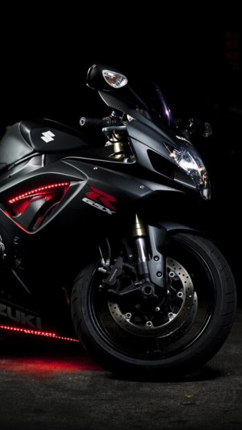 A black Suzuki street bike is parked with red accent lights illuminating the ground nearby, HD Phone Wallpaper