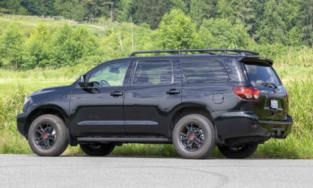 A black Toyota Sequoia is parked on a road with trees and grass in the background, HD Desktop Wallpaper