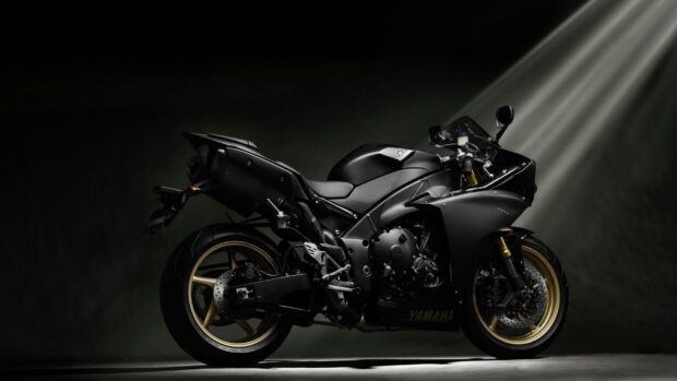 A black Yamaha street bike is showcased in dramatic lighting with golden wheels, HD Desktop Wallpaper