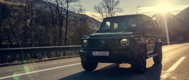 The off road driving vehicle is shown traveling on a scenic mountain road at sunset, 2K Desktop Wallpaper