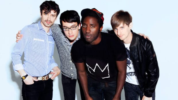 The Bloc Party band members pose together wearing casual outfits and looking at the camera, HD Desktop Wallpaper
