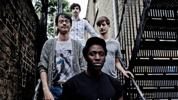 The Bloc Party band members pose outdoors in a narrow alleyway, HD Desktop Wallpaper