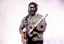 A Bloc Party Band guitarist passionately playing guitar and singing on stage, HD Desktop Wallpaper