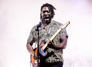 A Bloc Party Band guitarist passionately playing guitar and singing on stage, HD Desktop Wallpaper