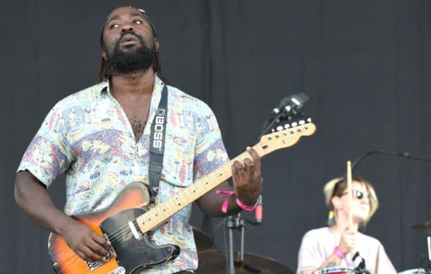 A Bloc Party Band guitarist plays an electric guitar during a live concert, HD Desktop Wallpaper