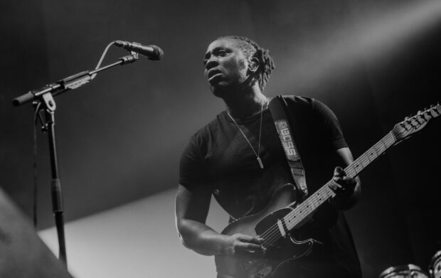 A Bloc Party band member plays guitar on stage during a live concert, HD Desktop Wallpaper